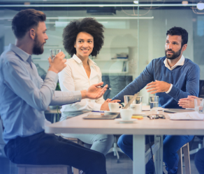 2 men and a woman talking at a table, illustrating ABM Performance Services for gathering places