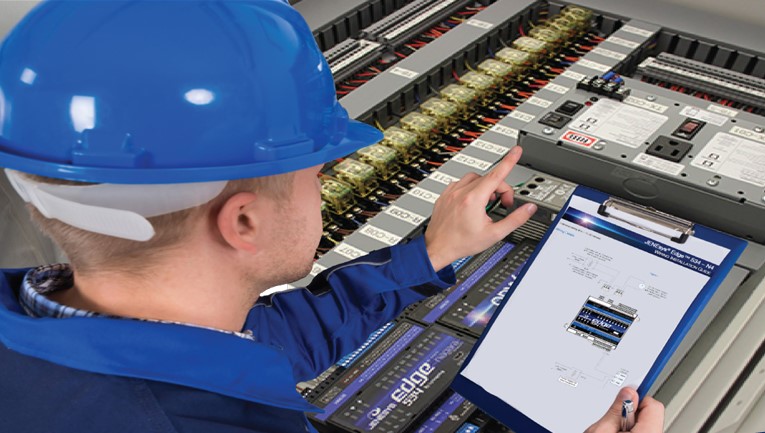 Man in blue hardhat and work uniform adjusting building system