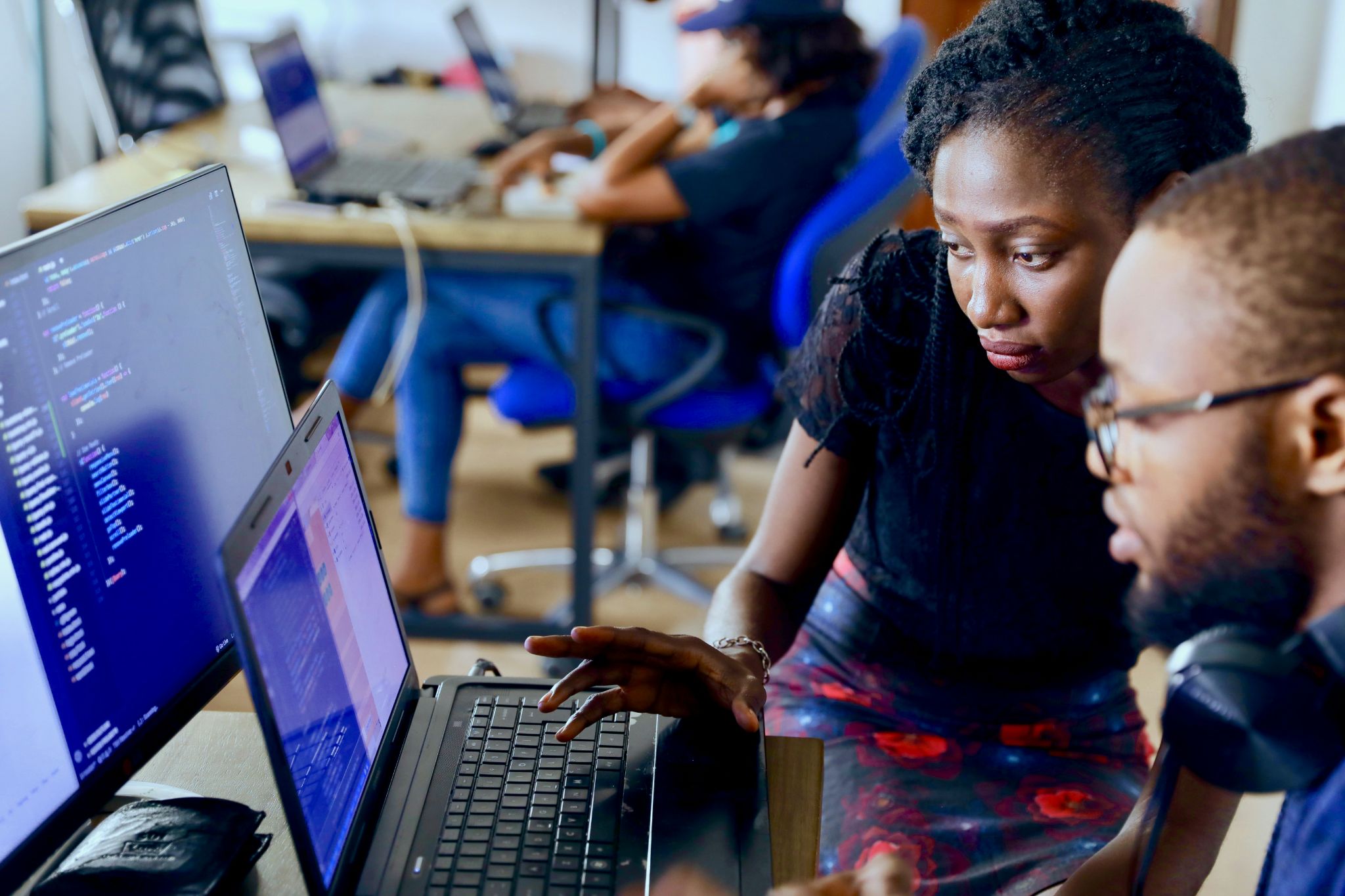 2 people checking computer screens in office setting