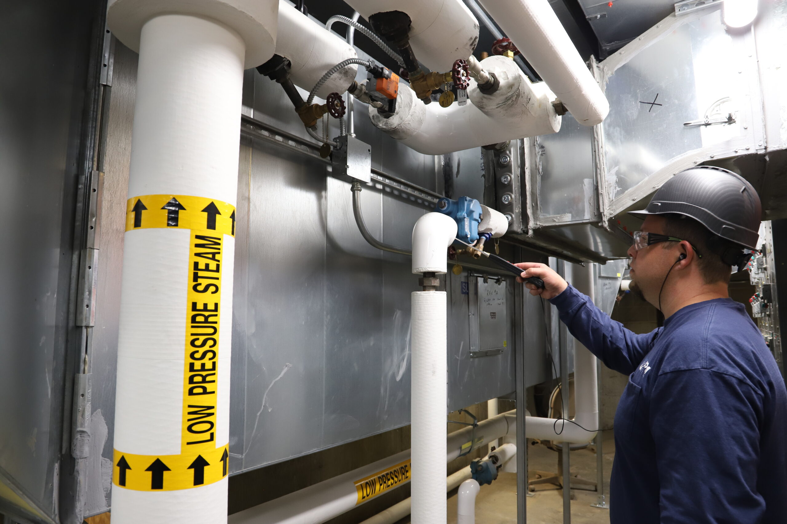 Man working on commercial water pipes