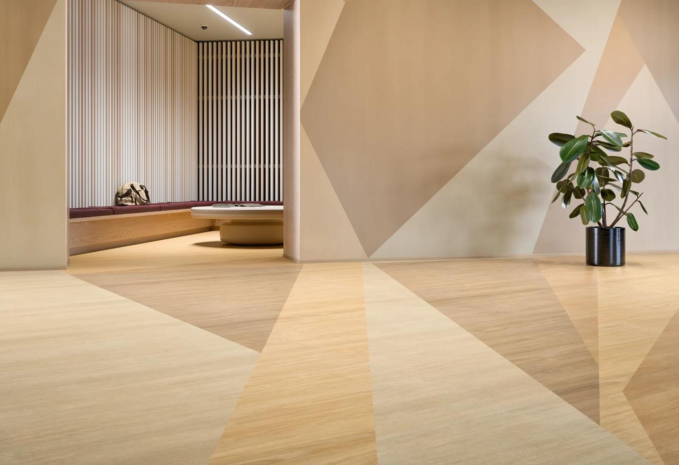 Heterogeneous sheet flooring installed, in beige and tan tones