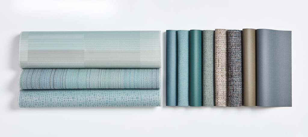 Swatches of folded textiles in blue-green tan and gray