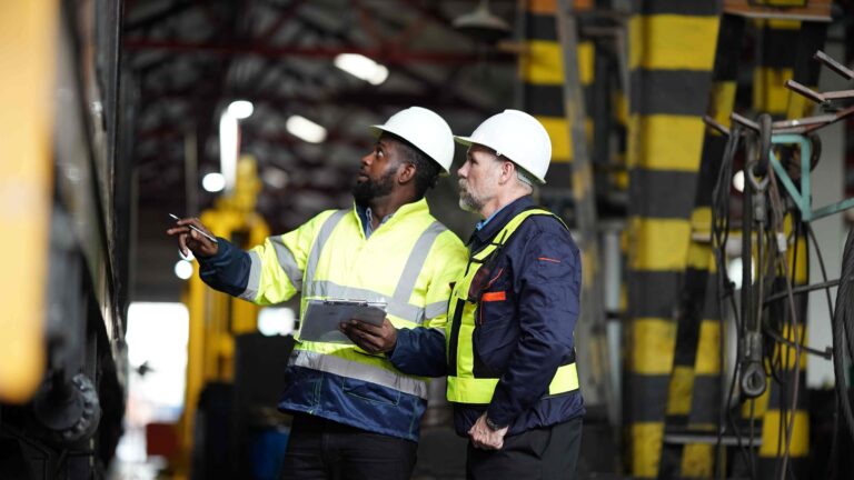 2 facilities professionals inspecting industrial heat transfer systems