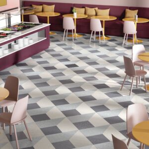 Cube-patterned flooring with small tables around the sides