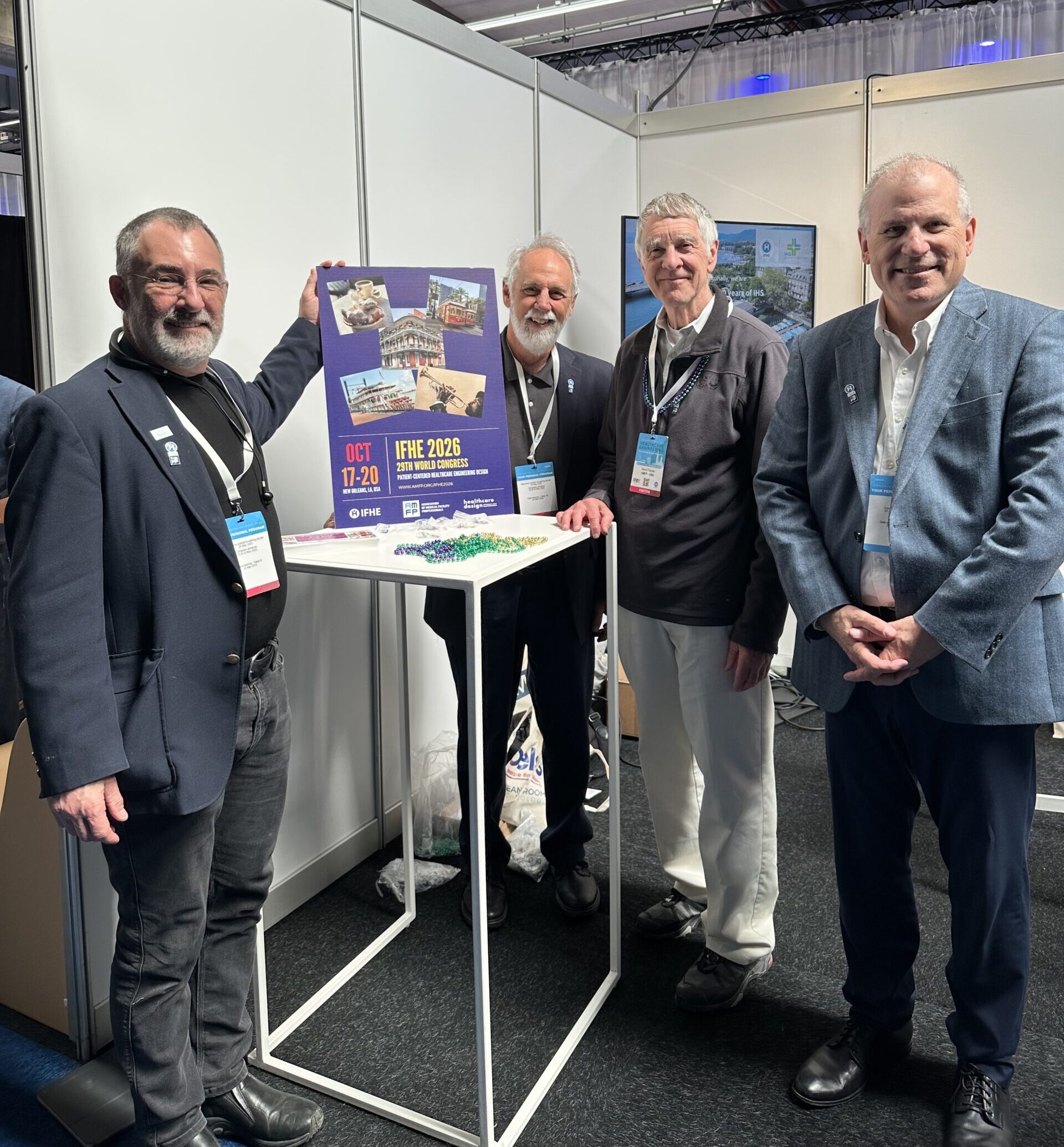 AMFP leaders at IFHE event - 4 men by small table