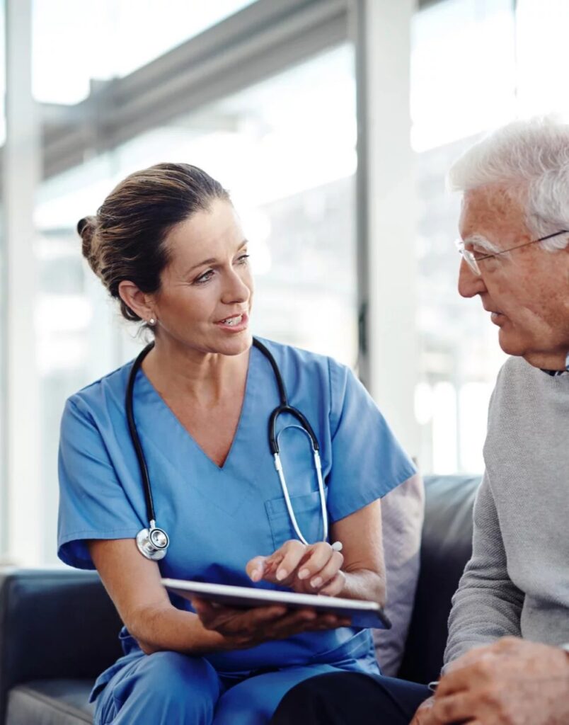 Female healthcare professional talking with older male patient