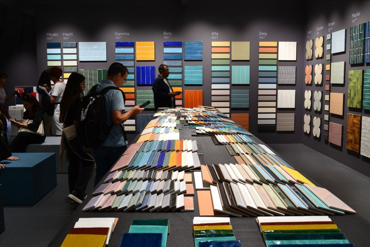 Porcelain and ceramic tile samples on a long table and walls at CERSAIE 2025