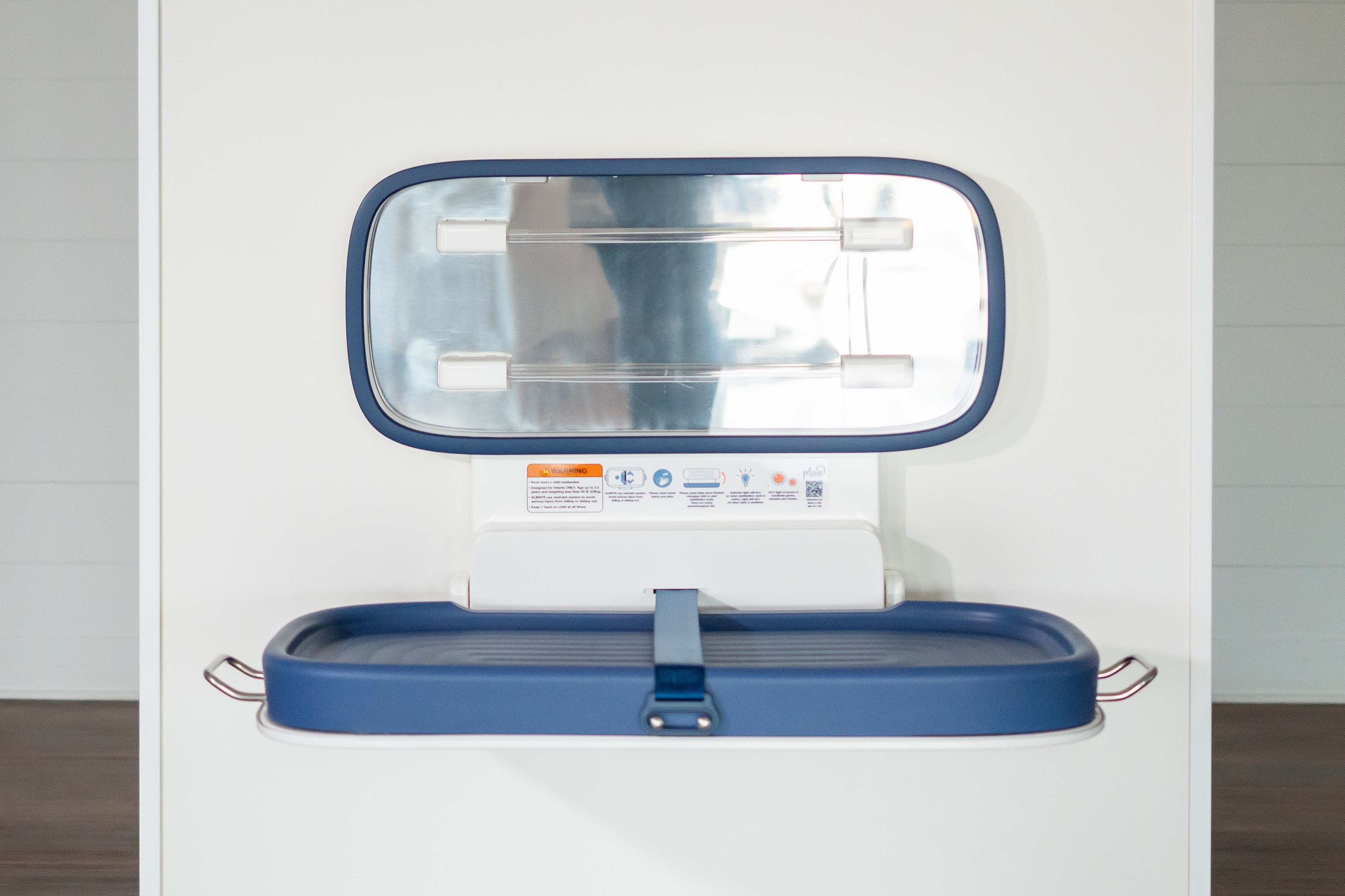 Pluie self-sanitizing diaper-changing table for public restrooms