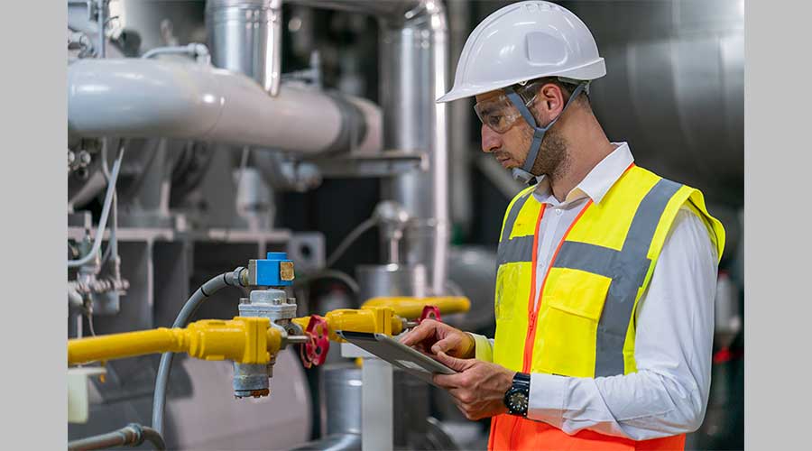 FM checking pipes to illustrate facility management strategies for effective maintenance