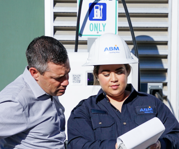 ABM - 2 people by EV charging station