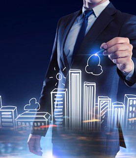 Man in suit drawing graphic buildings with laser